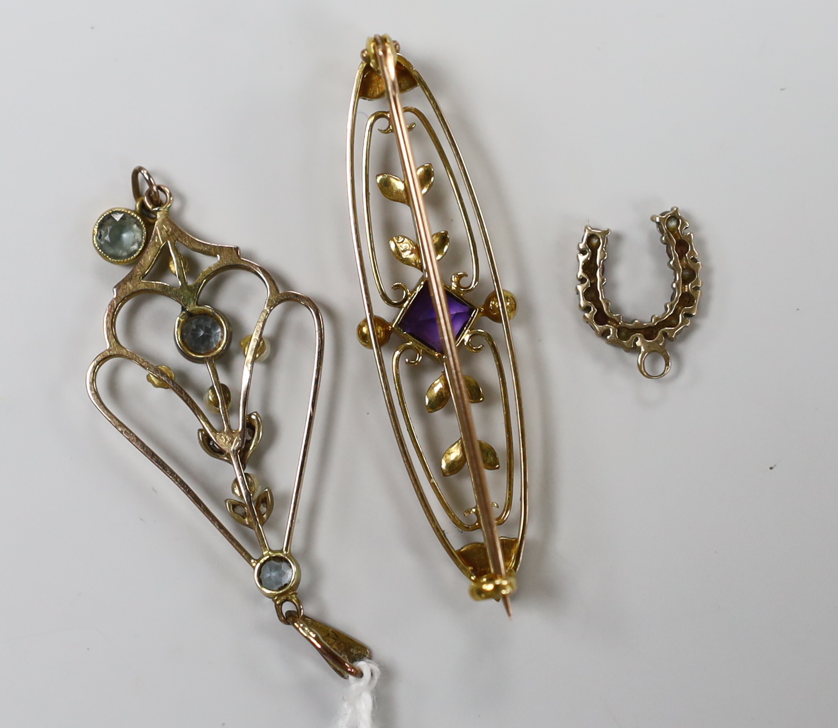 An Edwardian 15ct, aquamarine, diamond chip and seed pearl set drop pendant, 49mm and a similar amethyst and seed pearl set bar brooch, gross 6.3 grams, together with a gem set horseshoe charm and a pair of gold plated d